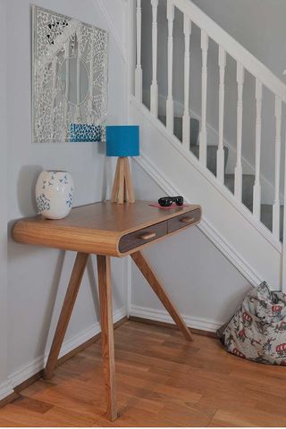 white and pale blue hallways with Mid-century wooden table to declutter to show how to organise a small hallway