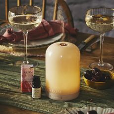 Neom wellbeing pod on table with champagne coupes