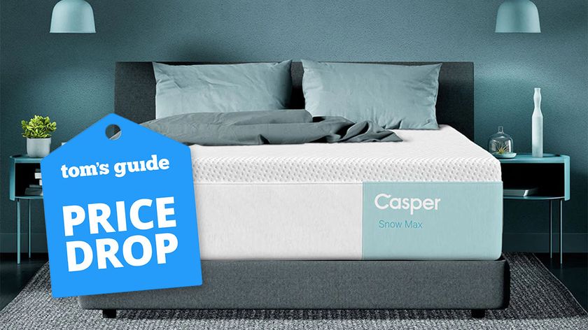 A Casper Snow Max Hybrid mattress in a bedroom between two side tables, a Tom&#039;s Guide price drop deals graphic (left)