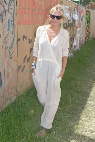 Sienna Miller at Glastonbury in 2019 wearing a white jumpsuit