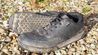 A pair of Shimano GF600 shoes on a gravelly background