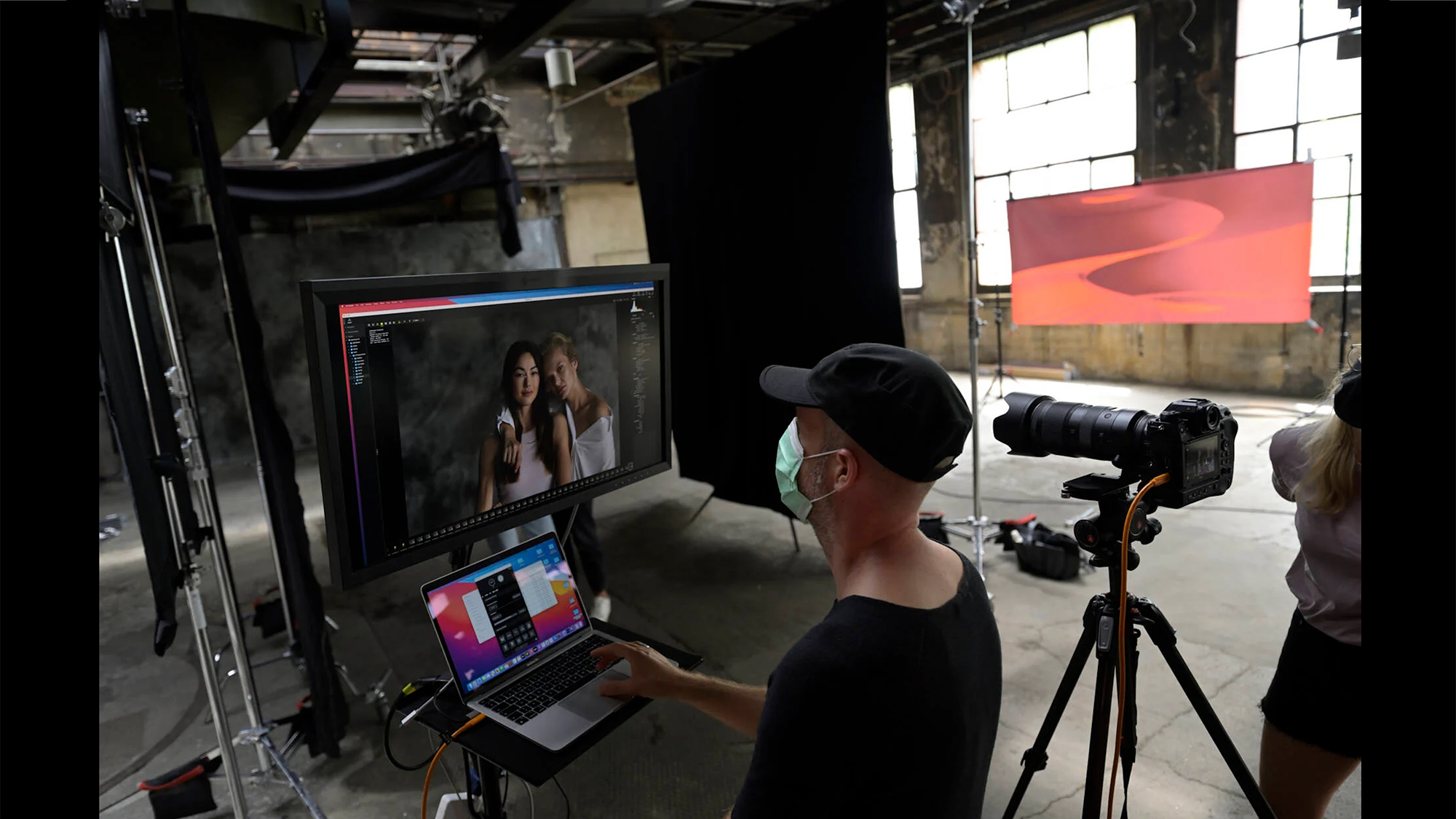 A man reviewing an image on a monitor via Nikon NX Tether in a photo studio