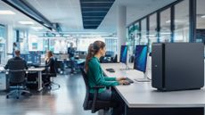 Female knowledge worker using a Dell Pro Max with GB300 desktop computer in an open place office space.