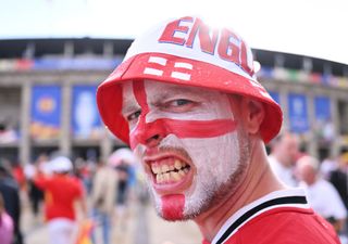 A fan of England poses for a photo while wearing face paint in the colours of the national teams flag outside the stadium prior to the UEFA EURO 2024 final match between Spain and England at Olympiastadion on July 14, 2024 in Berlin, Germany.