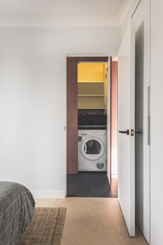 A hidden laundry cabinet in the passageway
