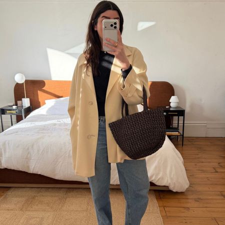 Influencer wears woven leather bag. 