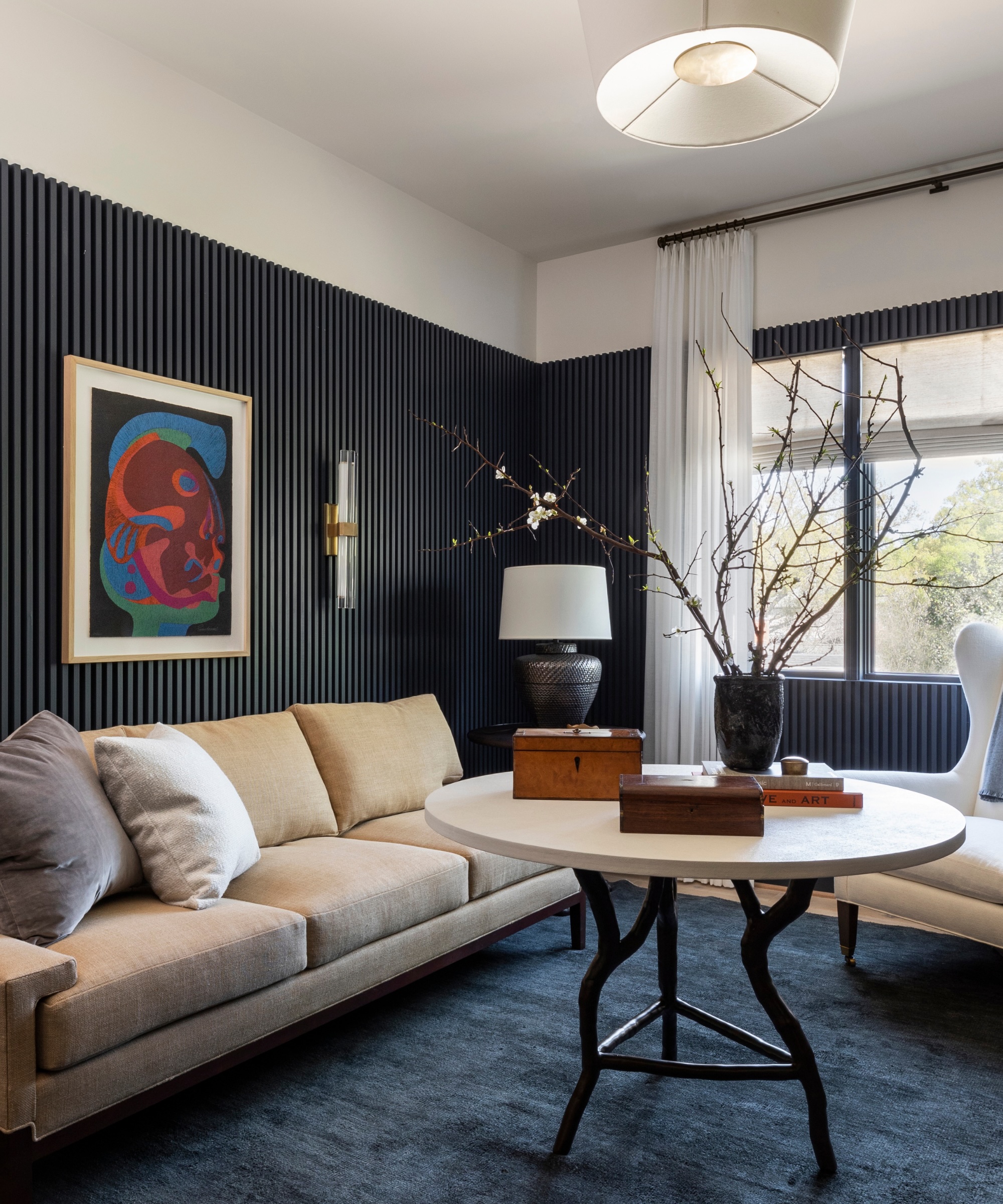 small living room painted in sark blue Mysterious by Benjamin Moore with a Cloud White trim