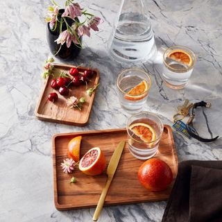 wooden trays with fruits and glass accessories