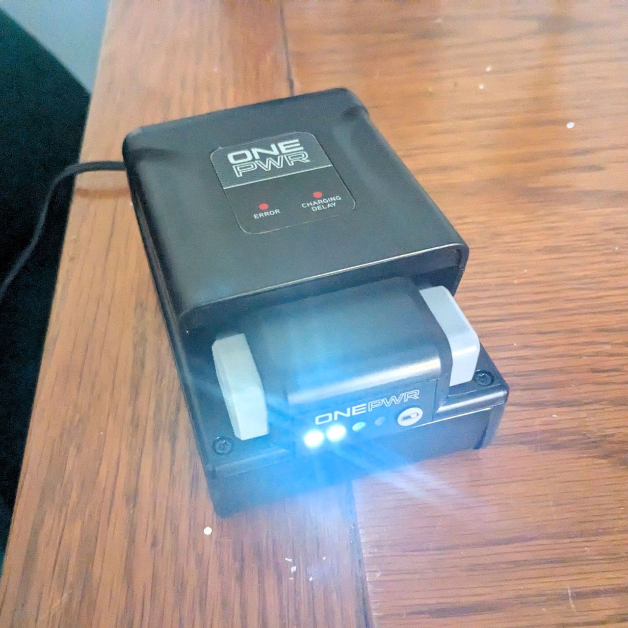 VAX Pace Plus battery on charge on wooden table