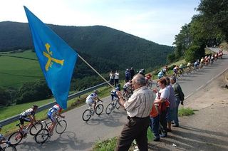 The Asturia flag flies as the riders pass.