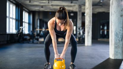 woman holding a kettlebell