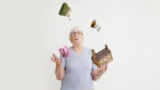 An older woman juggles items representing expenses, such as a piggy bank and a pill bottle.