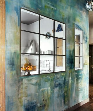 view of kitchen through glazed windows with mottled paint effect wall