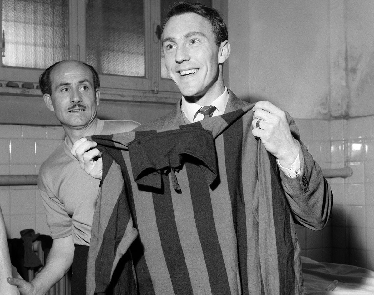 England striker Jimmy Greaves holds his new shirt after signing for Milan in 1961