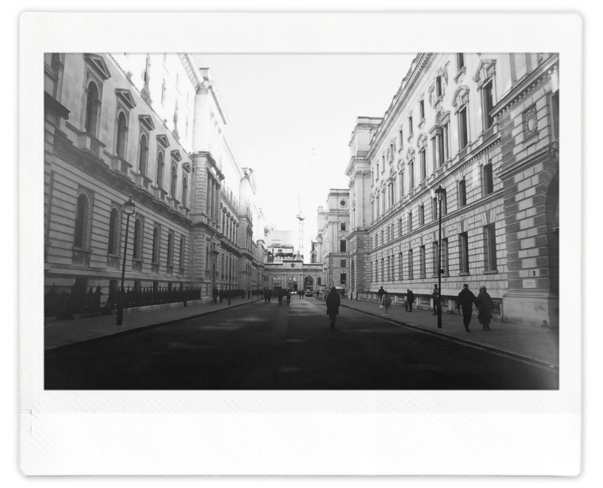 A street in central London flanked by large buildings