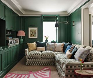 Small green living room with large patterned corner sofa