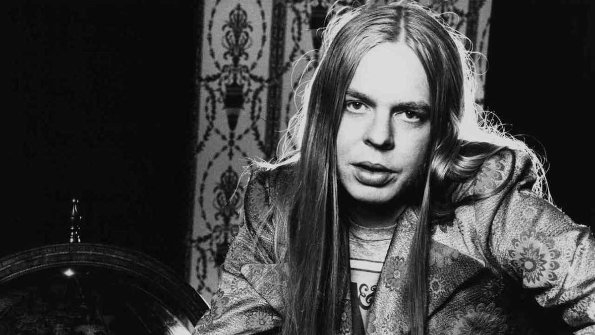 Rick Wakeman seated next to a globe in 1972