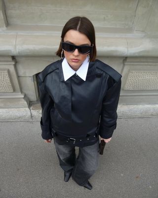 woman wearing black leather jacket and light black jeans