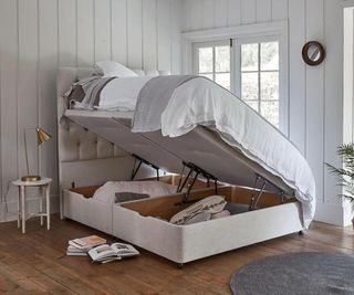 ottoman storage bed open to one side showing contents stored inside