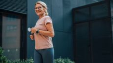 Woman wearing glasses and activewear, smiling