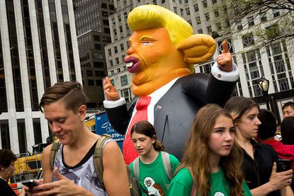 An inflatable rat that looks like Donald Trump.