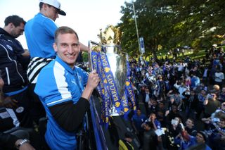 Marc Albrighton smiles while holding the Premier League trophy at Leicester City's title victory parade, 2016