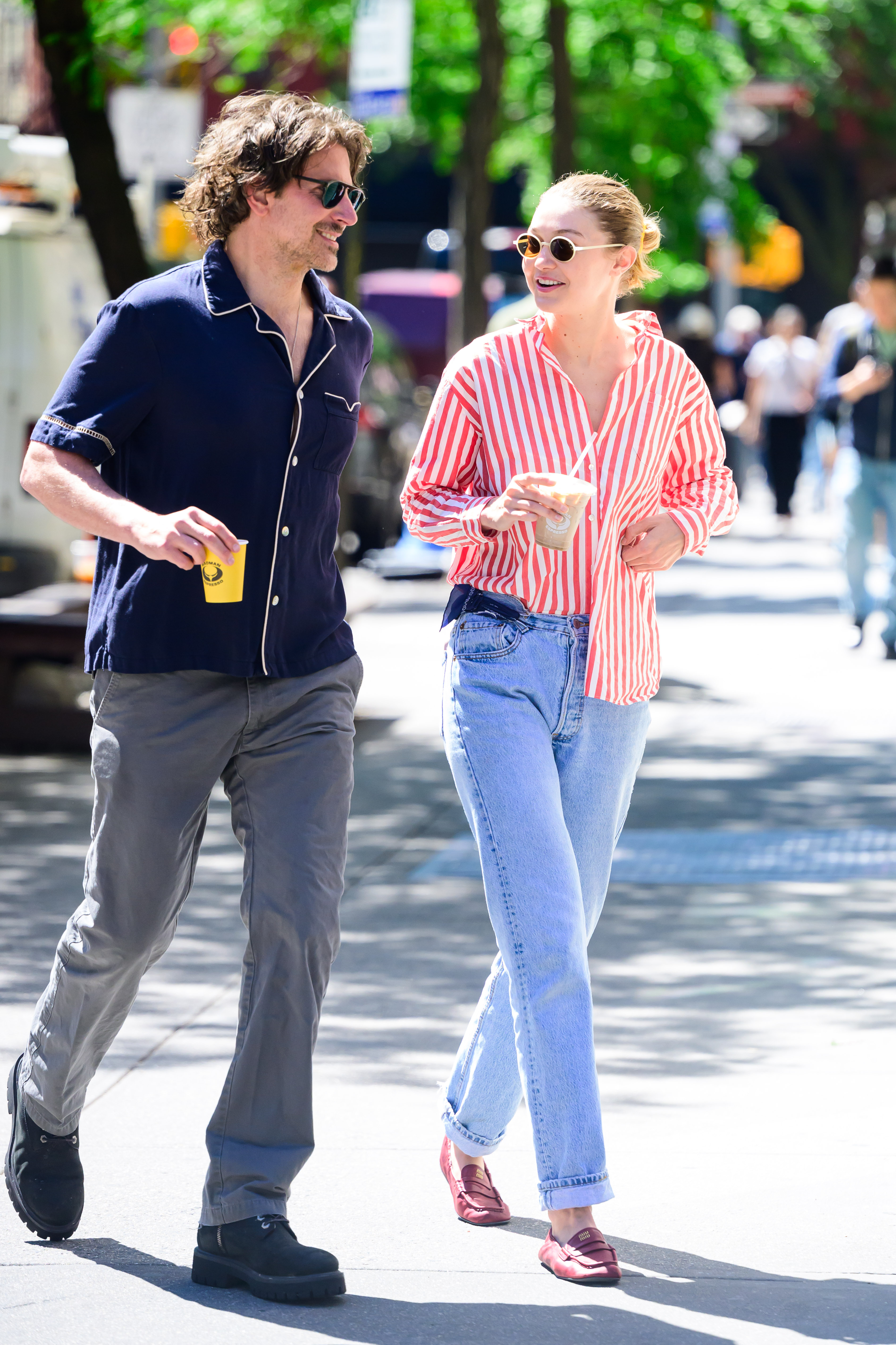 gigi hadid is seen on a coffee run with boyfriend bradley cooper wearing vintage jeans and a red striped button-down