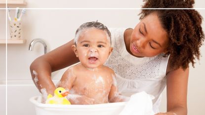 Image of woman bathing baby with bath foam on their face