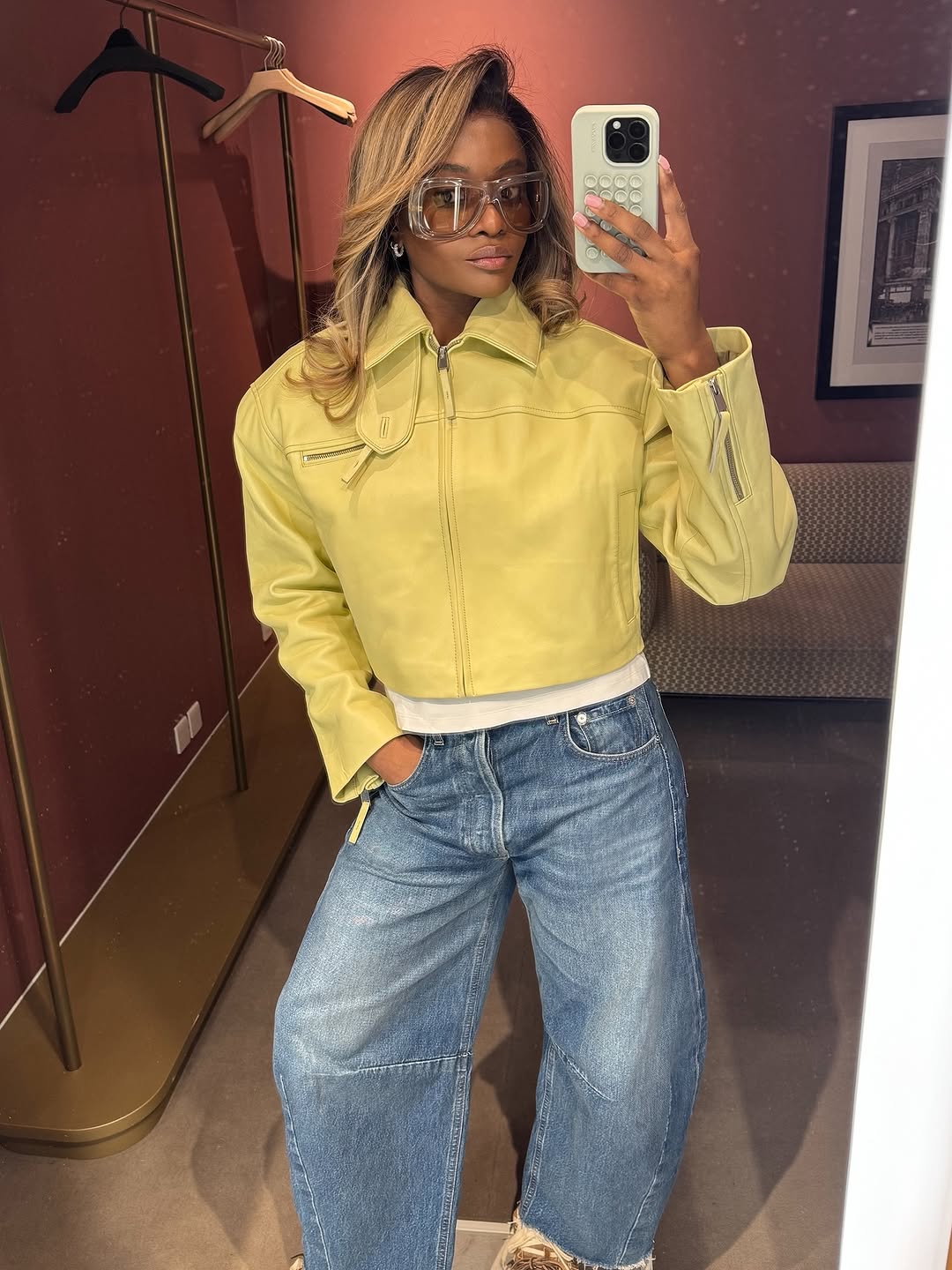 A woman wearing a yellow jacket and denim, one of the biggest 2026 spring color pairings.