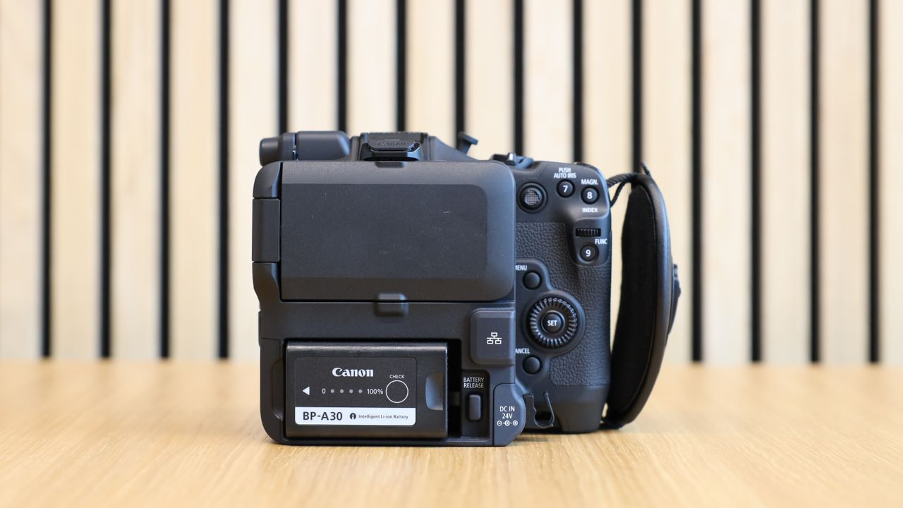 Canon EOS C80 cinema camera on wooden desk with wooden paneling behind