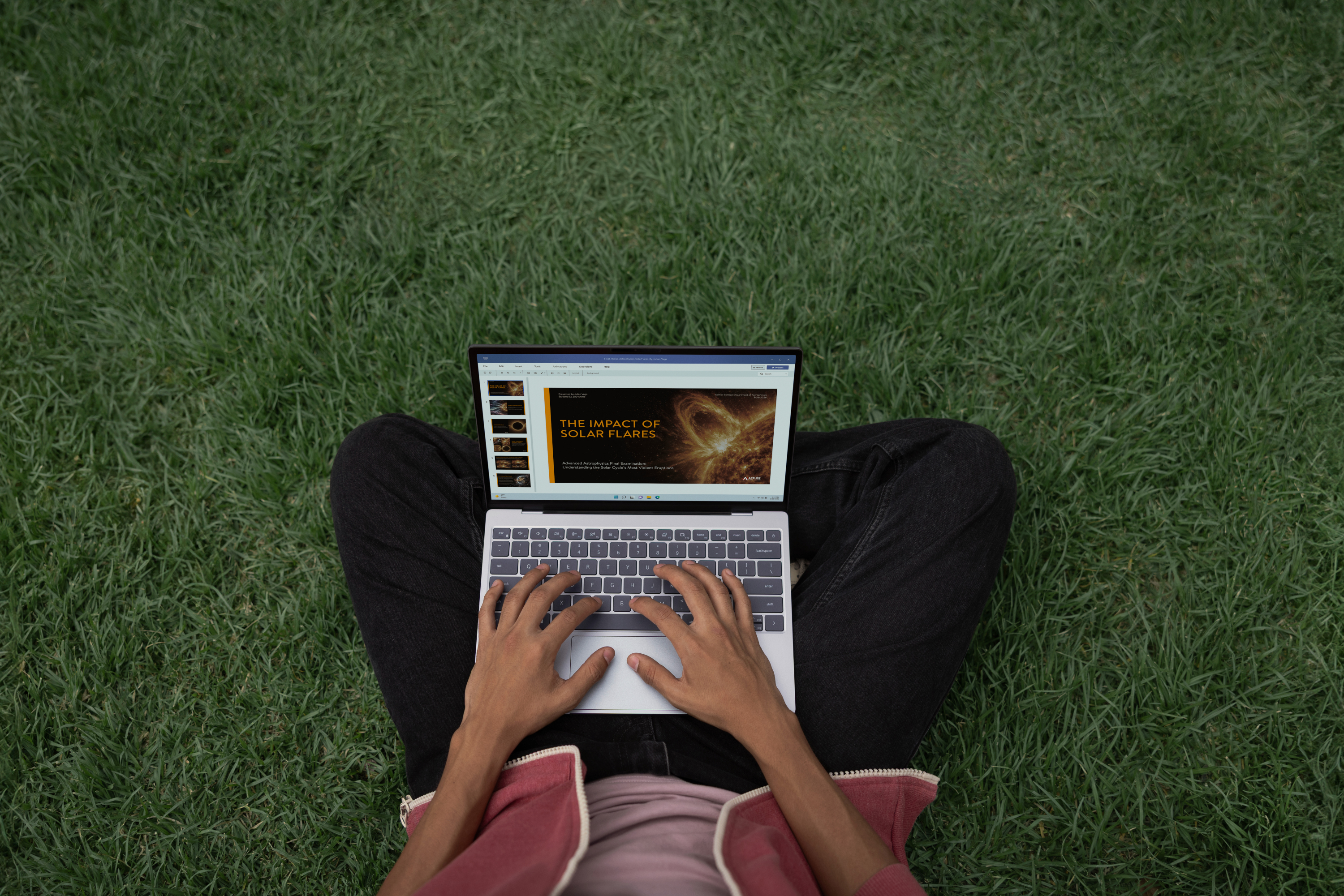 Person sitting on grass, using an XPS 13 laptop with a presentation slide titled "The Impact of Solar Flares" displayed on the screen.