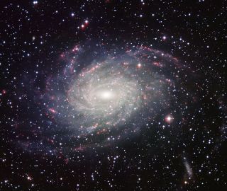Astronomers think the spiral galaxy that most closely resembles our own Milky Way is this one, NGC 6744. While the structure is the same, it is estimated to be twice as massive. The pink and purple knots show where new stars are being created. The galaxy's light has taken 29.8 million years to reach Earth. Unfortunately for Northern Hemisphere skywatchers, it is visible only from the Southern Hemisphere.