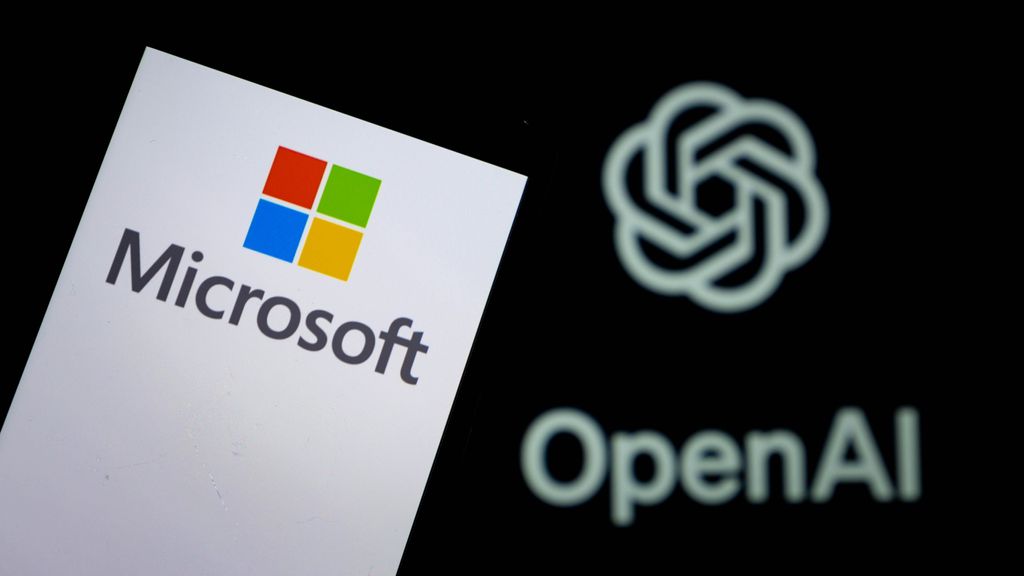 The Microsoft logo displayed on a smartphone with the OpenAI logo in the background.