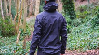 The back of a rider in a waterproof jacket