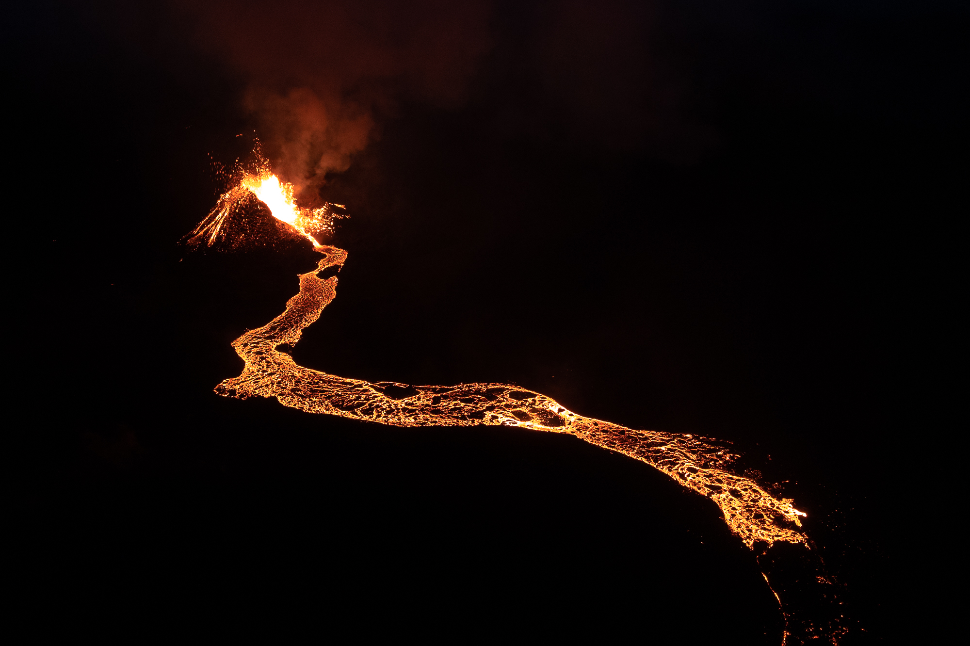 Photo captured by photographer and filmmaker Karim Iliya, showing lava pouring across a landscape at an active volcano in Iceland. Karim Iliya won the Drone (Video) prize in the 14th season of HIPA.