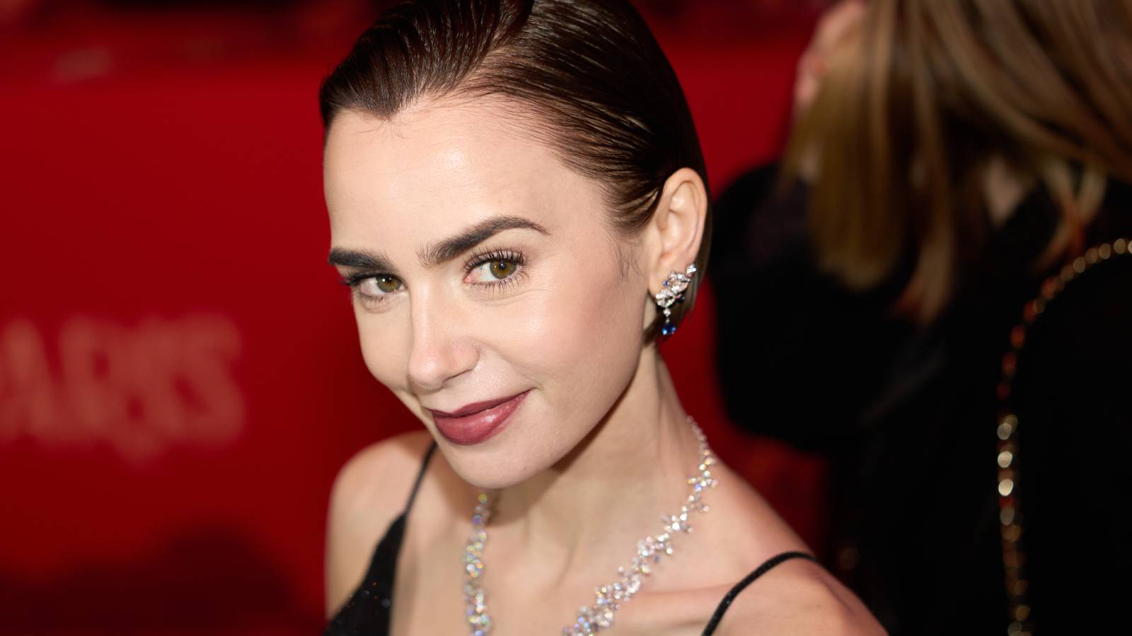 Lily Collins smiles into the camera