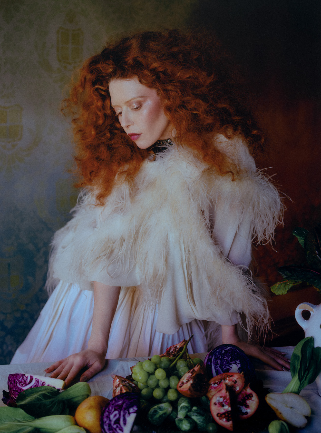 natasha lyonne wearing a feathered cape and a long flowy dress