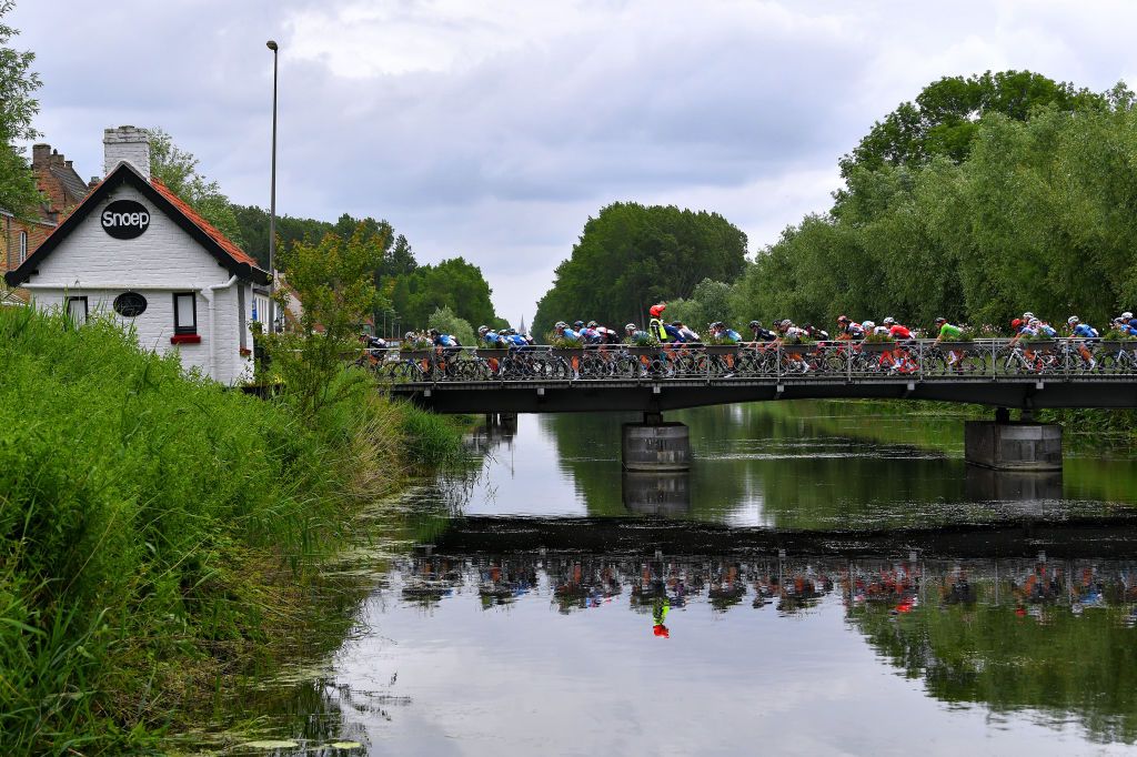 BRUGGE BELGIUM JUNE 23 The peloton passing through bridge during the 9th Lotto Belgium Tour 2021 Stage 1 a 1126km stage from Blankenberge to Bruges Landscape River LottoBelgTour LottoBelgiumTour on June 23 2021 in Brugge Belgium Photo by Luc ClaessenGetty Images