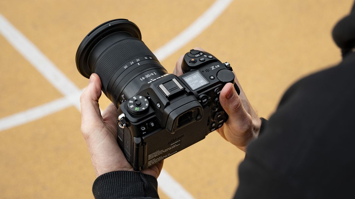 Nikon Z6 III camera in the hand from over the photographer's shoulder