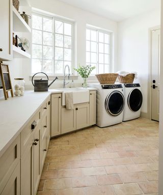 laundry room with terracotta floors