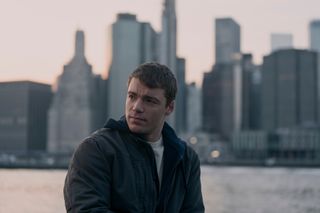 gabriel basso as peter sutherland standing by the new york city water front in the night agent season 2