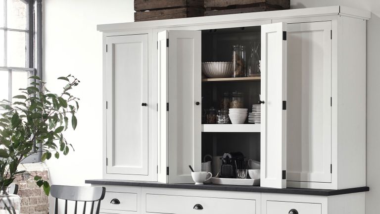 white kitchen cabinetry concealing appliances
