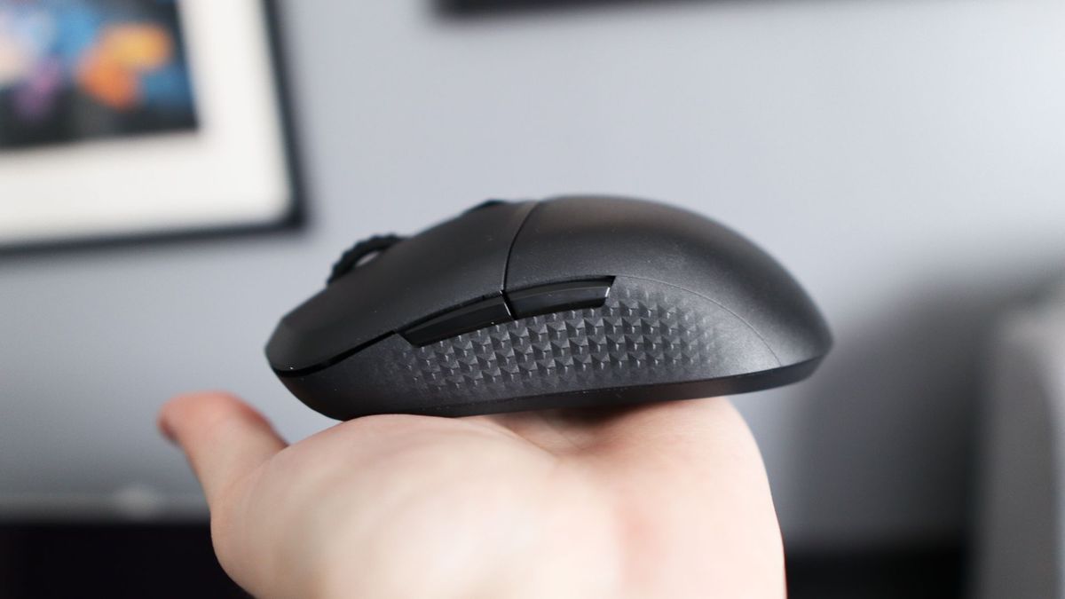 MSI Versa 300 Wireless 8K on a desk and held in a hand.