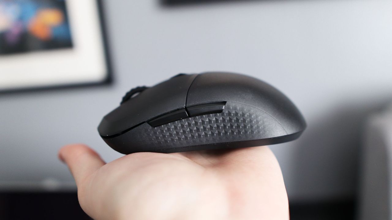 MSI Versa 300 Wireless 8K on a desk and held in a hand.