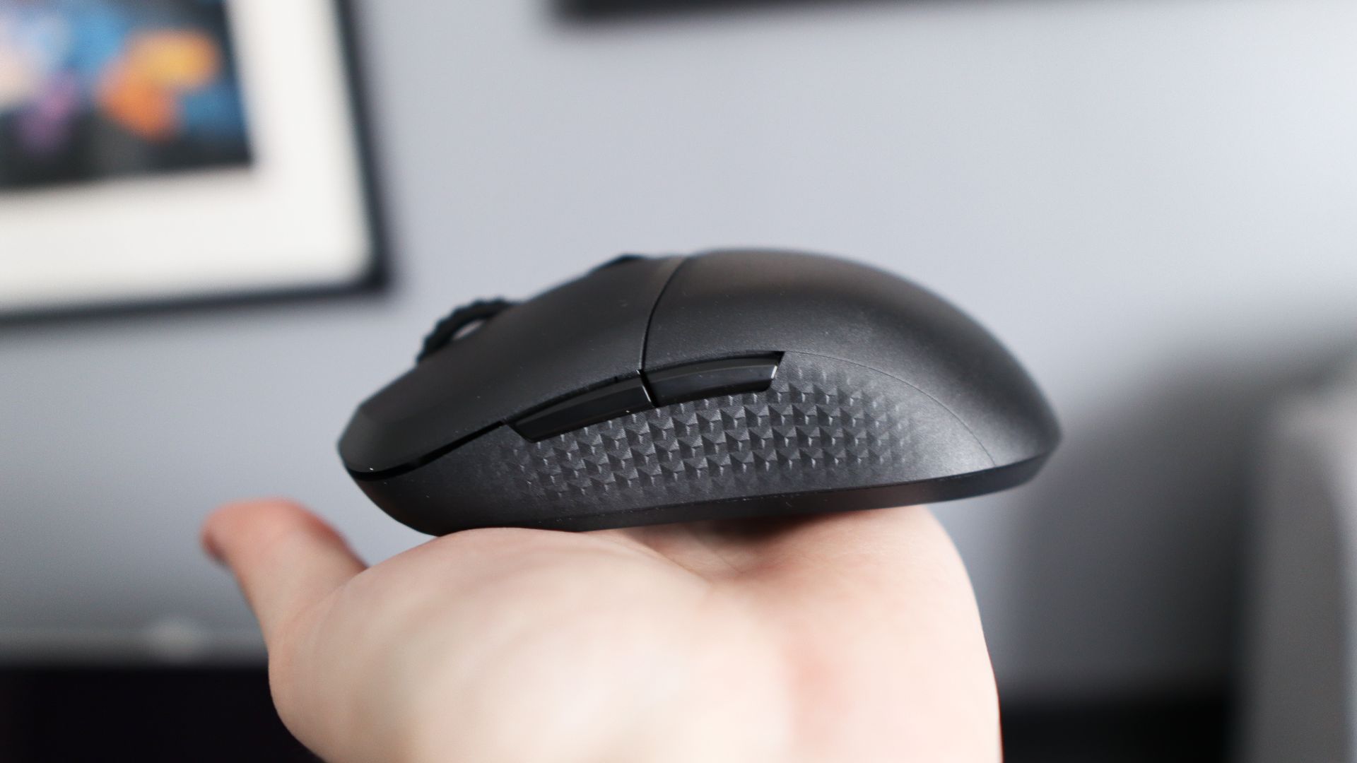 MSI Versa 300 Wireless 8K on a desk and held in a hand.