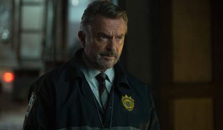 The Commuter Sam Neill looking concerned in his police windbreaker