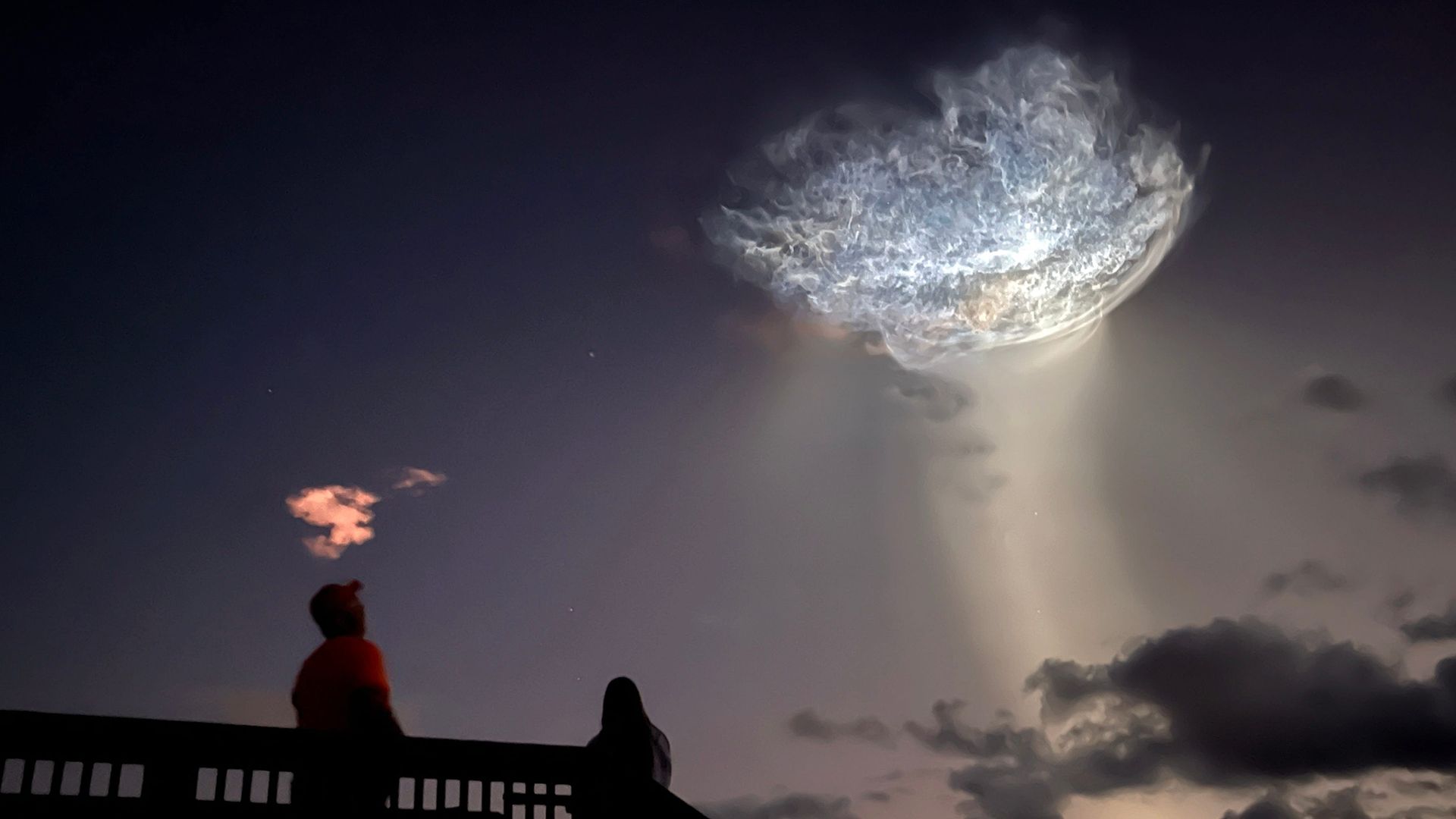 Sunlight illuminates the exhaust plume of a SpaceX Falcon 9 rocket to create a 