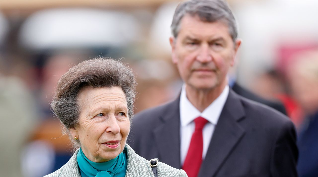 Princess Anne wears a green pussybow shirt with a tweed jacket and husband Sir Timothy Laurence walks behind her