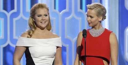 In this handout photo provided by NBCUniversal, Presenters Amy Schumer and Jennifer Lawrence speak onstage during the 73rd Annual Golden Globe Awards at The Beverly Hilton Hotel on January 10, 2016 in Beverly Hills, California