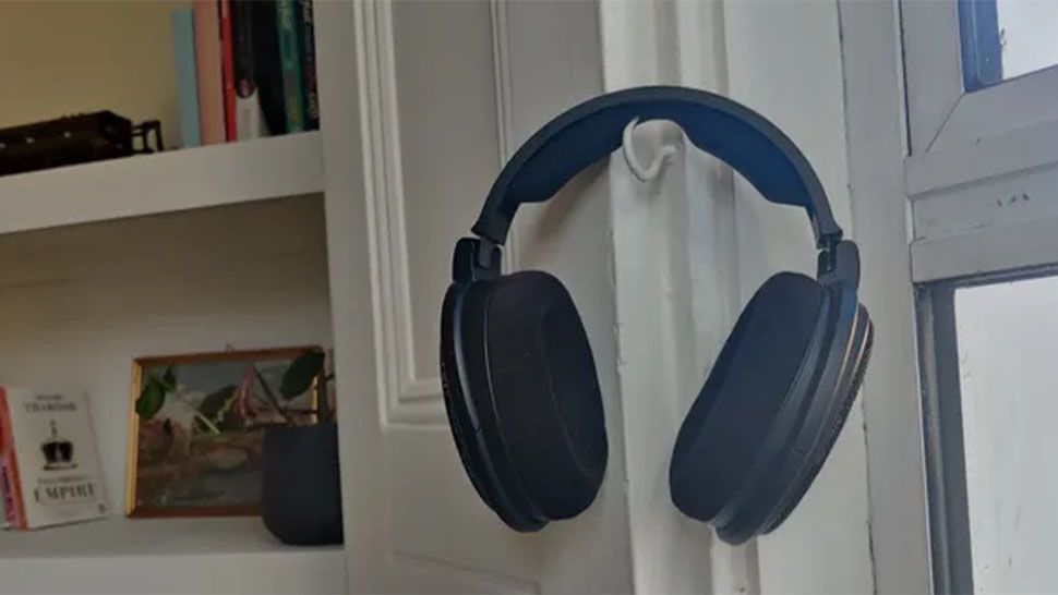 The Sennheiser HD 660S2 Wired Headphones hanging on a hook.